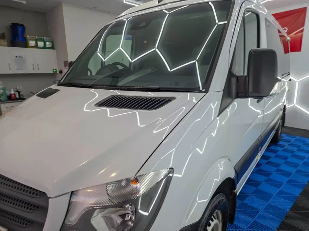 Hexagon lights reflected in freshly polished paint