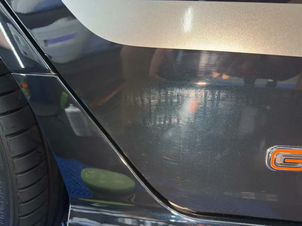 Paint correction on a dark grey panel