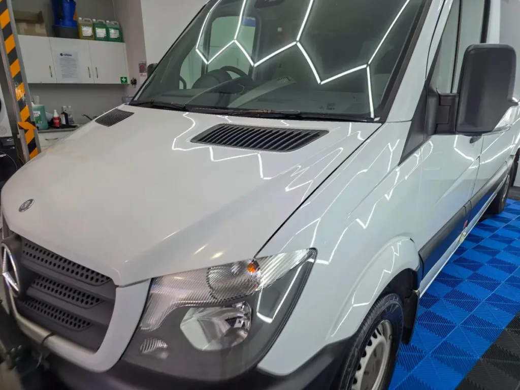Mercedes Sprinter after a machine polish under the studio hexagon lights