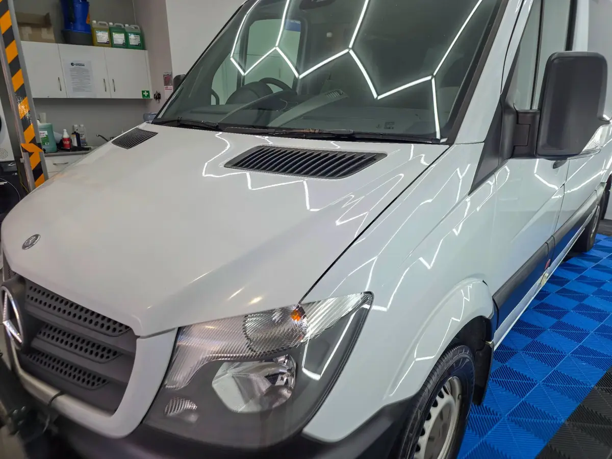 Mercedes Sprinter after a machine polish under the studio hexagon lights